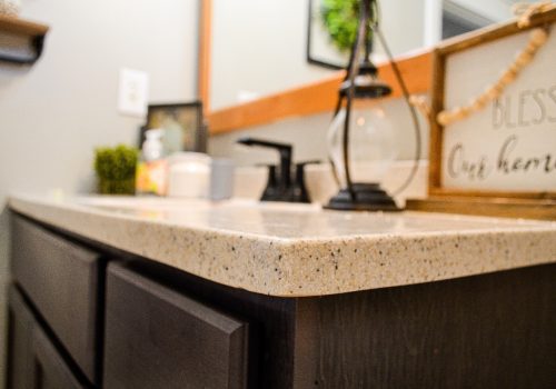 A closeup of a new countertop in a renovated bathroom by Derrick Services