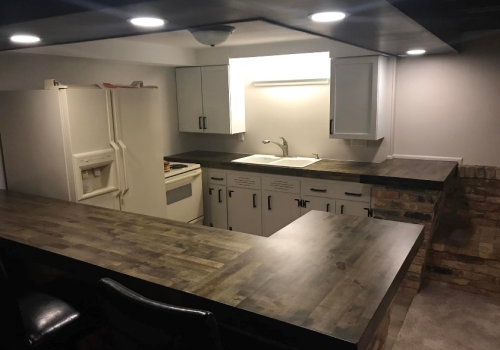 A bar/kitchen space in a basement renovated by Derrick Services